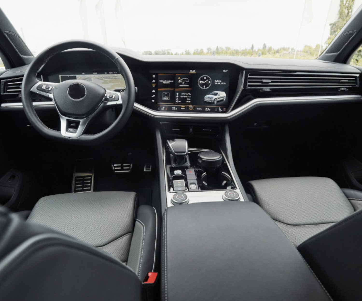 Interior of a prestigious modern black car. Leather comfortable seats and accessories and steering wheel.